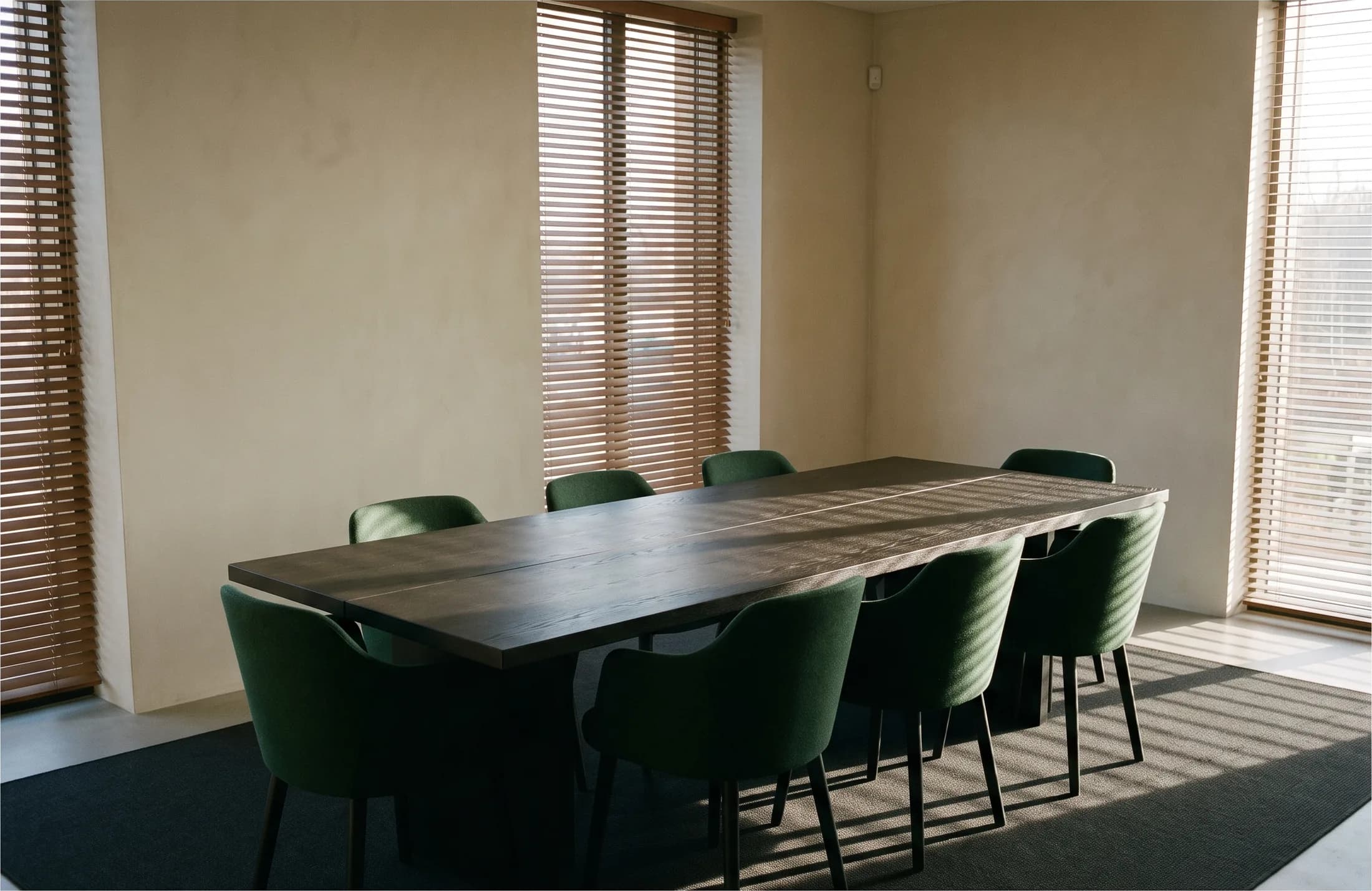 An empty meeting room in low winter light, ready for a scoping conversation